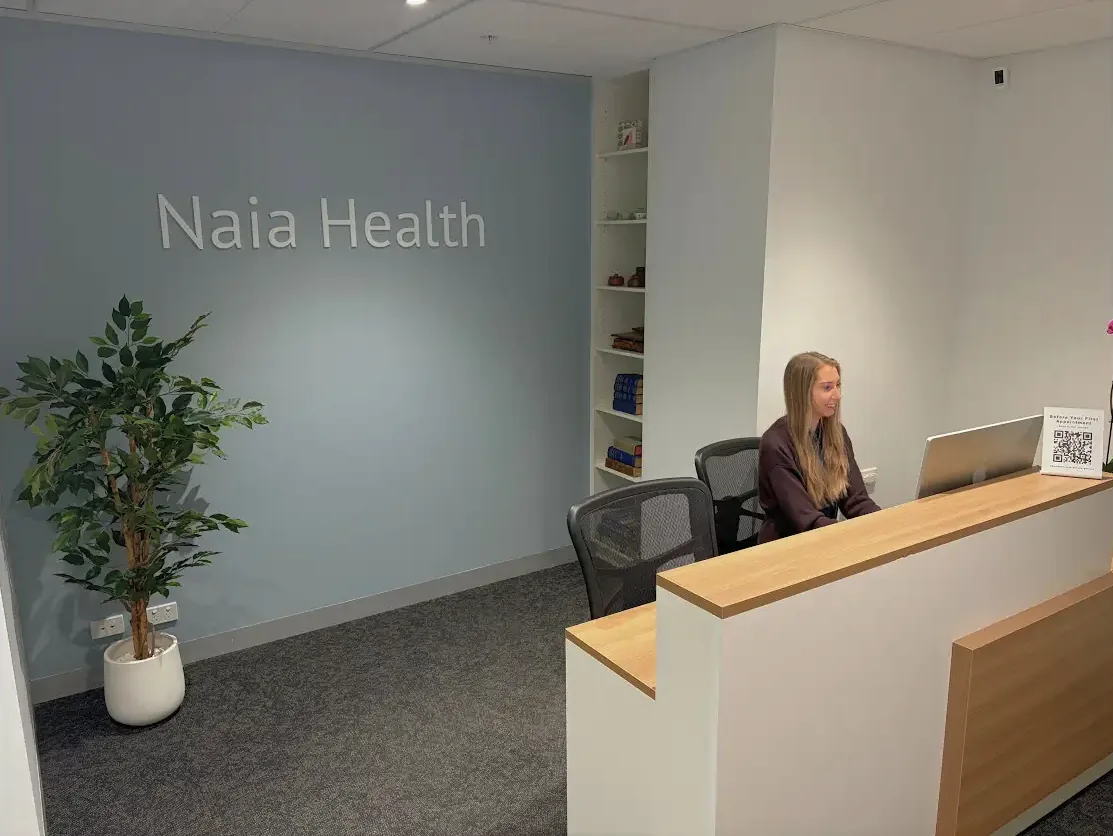 Team member at the Naia Health clinic reception desk